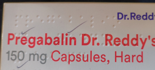 A photo of a medication box featuring handwritten ticks or checkmarks